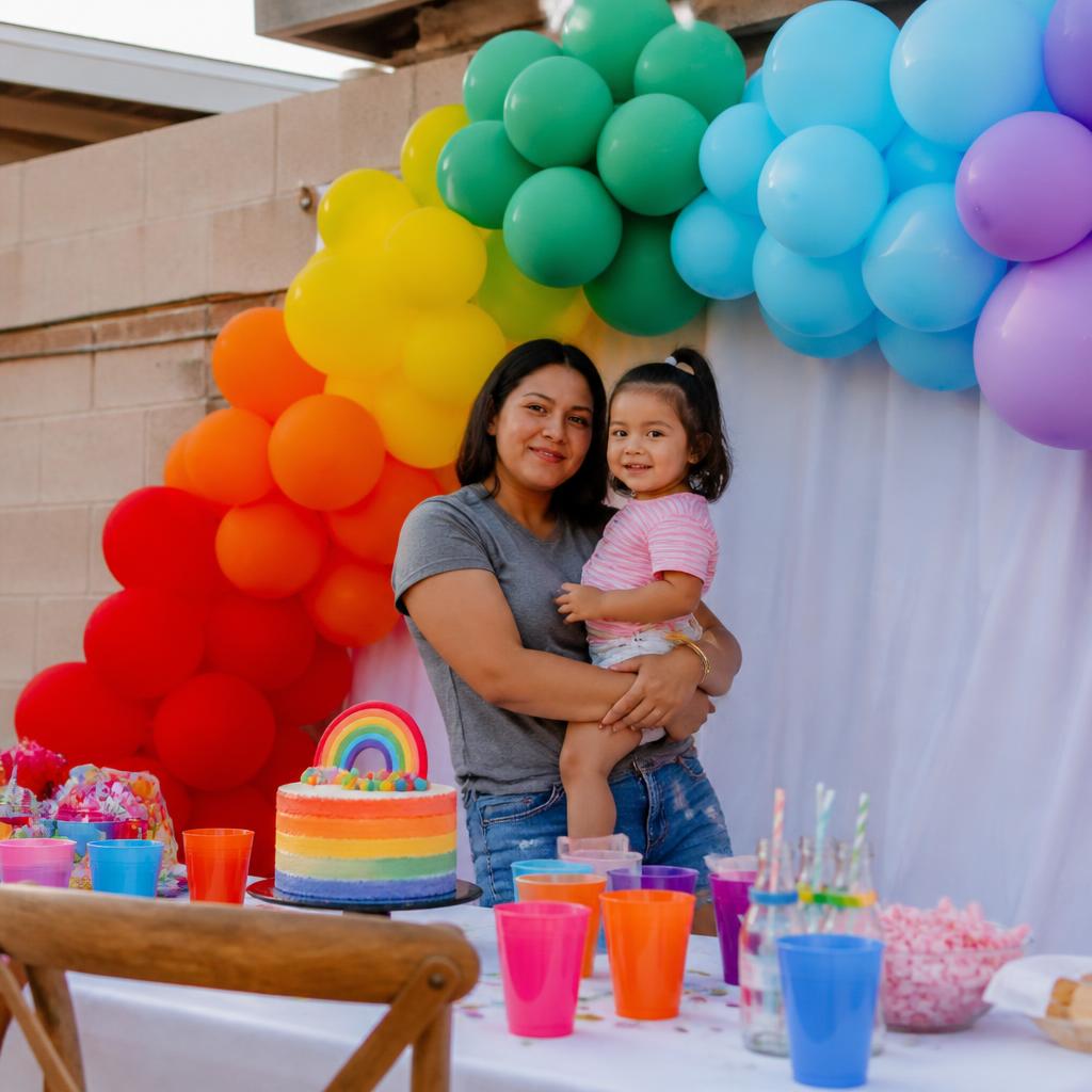 Rainbow balloon garland backdrop at a kids birthday party